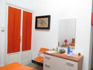 a room with a desk and a mirror at Guest House Erika in La Spezia