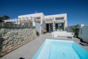 a villa with a swimming pool in front of a house at Casa Celeste con Piscina Privata a Otranto in Otranto