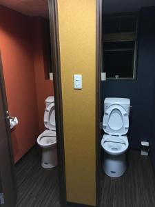 a bathroom with two toilets in a room at Park Inn in Osaka