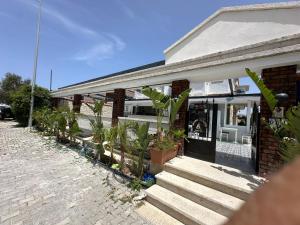 a house with plants in front of it at Grand Alaçatı Butik Hotel in Alaçatı
