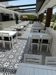 a row of tables and chairs on a patio at Grand Alaçatı Butik Hotel in Alaçatı