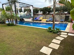 a house with a swimming pool in a yard at Grand Alaçatı Butik Hotel in Alaçatı