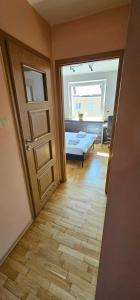 a room with a door and a room with a bed at Apartament Gdynia Babie Doły in Gdynia