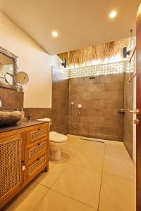 a bathroom with a toilet and a sink and a shower at 360 Surf Lodge in Kuta Lombok +61 photos