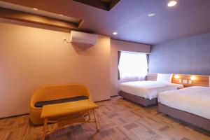 En eller flere senger på et rom på Ooedo Onsen Monogatari Premium Iseshima
