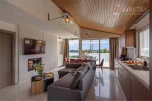 a living room with a couch and a kitchen at Akali Apartment airport by Airstay in Spáta