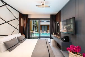 a bedroom with a bed and a view of a pool at The Grey Alaçatı in Çeşme