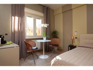 Schlafzimmer mit einem Bett, einem Tisch und Stühlen in der Unterkunft Alex's Guest House in Rom
