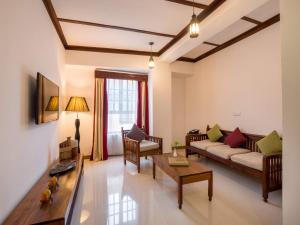 a living room with a couch and a table at Spice Tree by Turaco in Zanzibar City