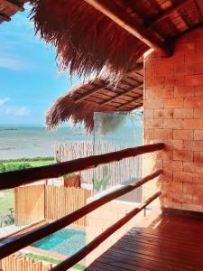 a view of the beach from a straw umbrella at Casa piscina privativa e vista-mar - Milagres in Passo de Camarajibe