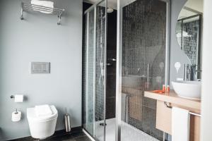 a bathroom with a shower and a toilet and a sink at Stay Hotel Porto Centro Trindade in Porto