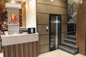 a lobby with a counter and a staircase in a building at Hotel Samrat Ajmer in Ajmer