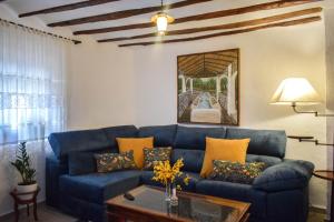 a living room with a blue couch and a table at Casa Rural Pilón Azul in Belerdas