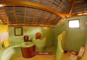 a bathroom with a sink and a toilet in it at Les Collines De Niassam in Palmarin +177 photos