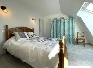 1 dormitorio con 1 cama y 1 silla en el ático en Lendre, en Méritein