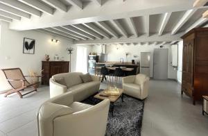 Una sala de estar con un sofá y sillas y una mesa. en Lendre, en Méritein 28 fotos más