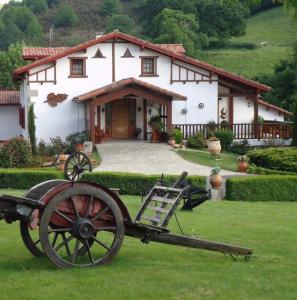 a statue of a cart in front of a house at Mentaxuria in Mendionde