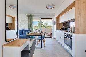 a kitchen and dining room with a table and chairs at Salt Bloom Apartments Nin in Nin