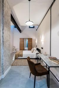 a bedroom with a bed and a desk at Loft Suite Frutos in Seville