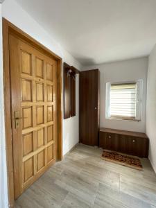 an empty room with a door and a window at FLH - Casa Gheti in Sighişoara
