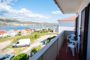 a balcony with a view of a body of water at Bepo i Marija A2 in Pag