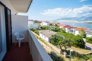 a balcony with a view of the water and buildings at Bepo i Marija A2 in Pag
