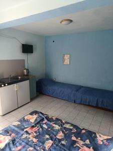 a living room with a bed and a kitchen at Eli Guest House in Balchik