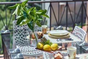 a table with a plate of lemons and a plant at SEAVIEW Apartment with POOL in Gornji Orahovac