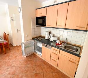 a small kitchen with a sink and a microwave at Ostseewelle 5 in Kühlungsborn