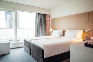 a hotel room with a large bed and a window at Stay Hotel Porto Centro Trindade in Porto +37 photos