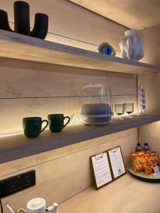 a shelf with two green cups on it at The CIVYT in Ubud