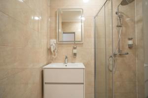 a bathroom with a sink and a shower at Villa Milan in Sveti Stefan