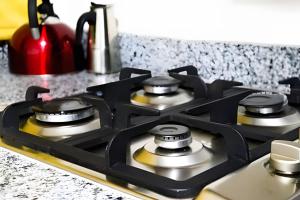 a stove top with four burners on a kitchen counter at Apart hotel Costa Verde,#1 Exclusivo y seguro con cama Queen in Las Galeras