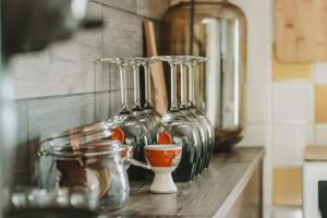 a counter with many glass jars on a counter top at Petite maison cosy Chez Georges in Auxonne +27 photos
