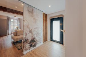 a living room with a wall mural and a door at L'Altana City House in Brescia
