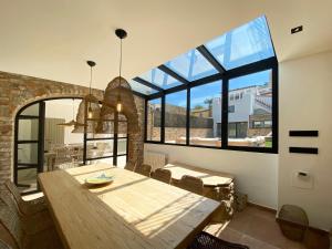 a dining room with a wooden table and large windows at Casa BlauBegur - ref 056 in Begur +18 photos