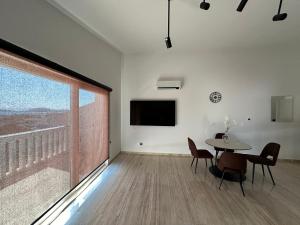 a dining room with a table and a large window at Zvončica Deluxe in Vodice