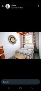 a picture of a room with two beds and a mirror at Edibesaadia in Essaouira