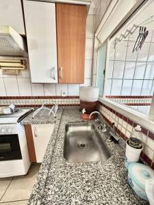 une cuisine avec un évier et un plan de travail dans l'établissement Apartamento Veneza, à Franca