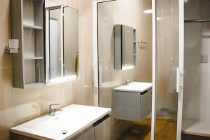 a bathroom with two sinks and a glass shower at Apart Hotel Costa Verde - #4 Exclusivo con cama Queen in Las Galeras +46 photos