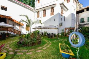 a courtyard of a house with a garden at Spice Tree by Turaco in Zanzibar City