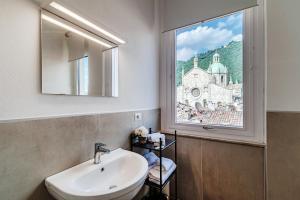 a bathroom with a sink and a window with a view at Downtown Como-Luxury Suites in Como +54 photos