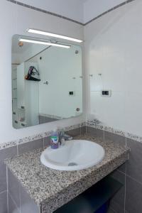 a bathroom with a sink and a large mirror at Maver apartment in Mali Lošinj