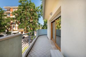 a balcony with a bench on the side of a building at VIP Bright experience Fano beach free parking in Fano