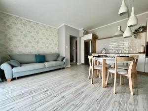 a living room with a couch and a table and chairs at EASY RENT- Nice, Centrum, 24h Check-in in Lublin