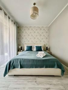 a bedroom with a large bed with two towels on it at EASY RENT- Nice, Centrum, 24h Check-in in Lublin