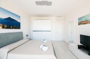 Ένα ή περισσότερα κρεβάτια σε δωμάτιο στο Minerva Luxury Apartment & Tulipan Apartment by Taormina Holidays