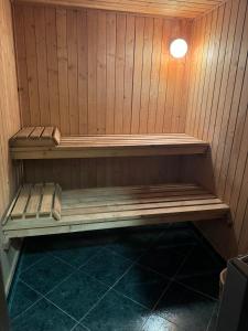 eine Sauna mit einer Holzbank in einem Zimmer in der Unterkunft Villa Rila Borovets with Hot Pool, Jacuzzi & Sauna by BookVillaBG in Borowez