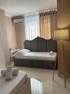 a living room with a bed and a couch at Edion Center Apartment in Shkodër +32 photos