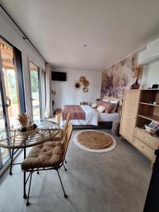 a bedroom with a bed and a glass table at Villa Sisyphe TINY HOUSE" la Odette" in Le Thoronet +28 photos
